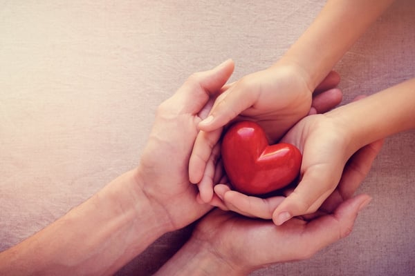 adult-and-child-hands-holiding-red-heart-health-care-love-give-hope-picture-id861080120