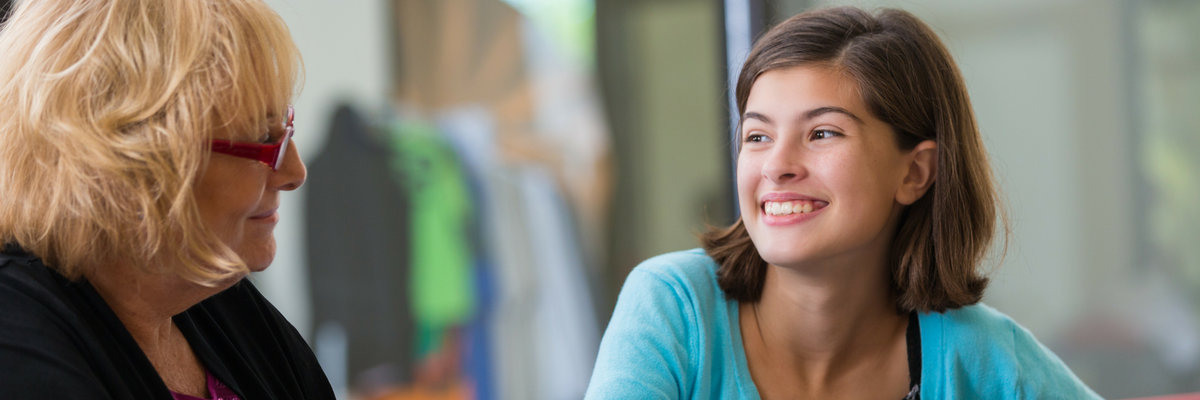 Teenage girl meeting with caring adult ministry leader | Sparkhouse Blog