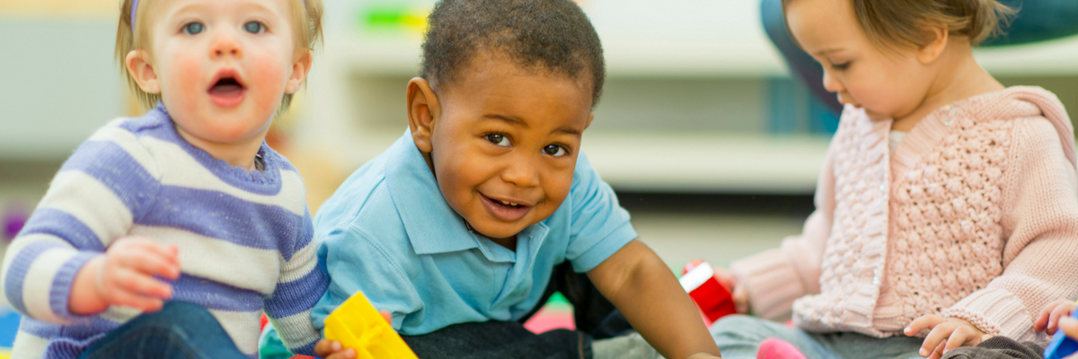 Babies playing together in a nursery | Sparkhouse Blog