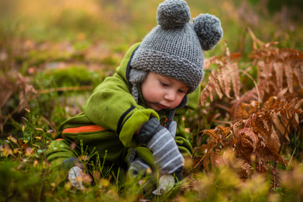Baby boy plays outside and observes leaves | Sparkhouse Blog