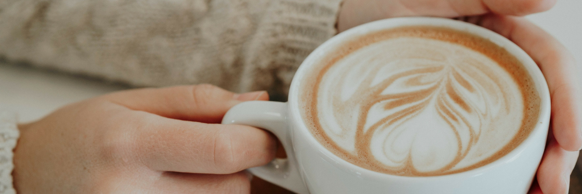 Photo of a person holding a relaxing coffee cup. Find spiritual fulfillment by filling your cup during Holy Week | Sparkhouse Blog