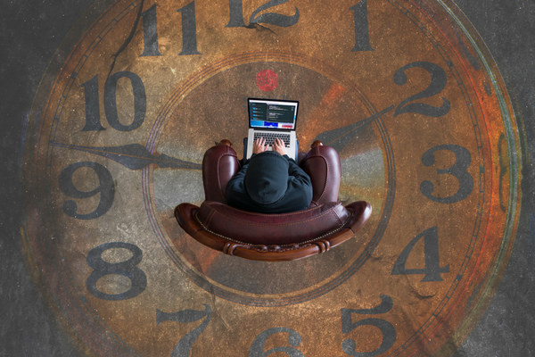 Church worker sits at computer in the middle of a giant clock | Sparkhouse Blog