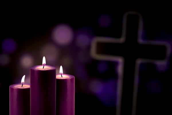 Purple candles and decorations light up a cross for lent | Sparkhouse Blog