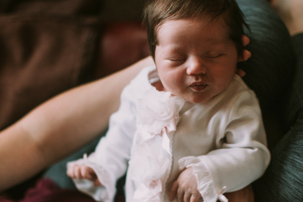 Woman holds a sleeping baby | Sparkhouse Blog