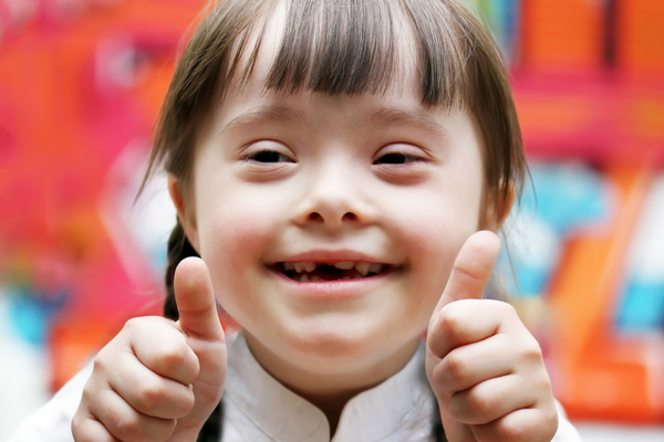 Girl with Down syndrome gives thumbs up | Sparkhouse Blog