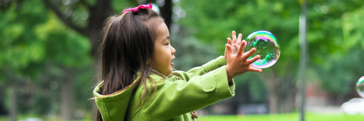 Cute little girl plays with a bubble—and learns! | Sparkhouse Blog