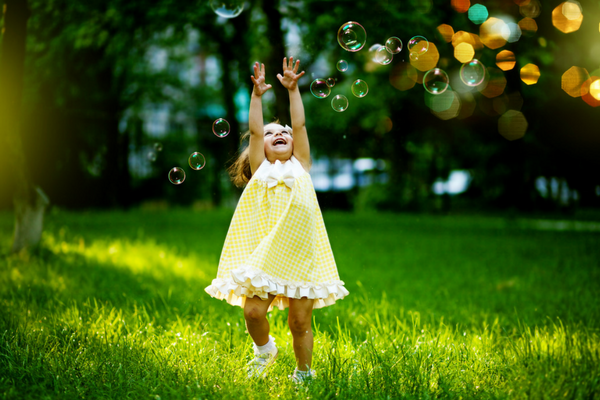 Little girl plays with bubbles | Sparkhouse Blog