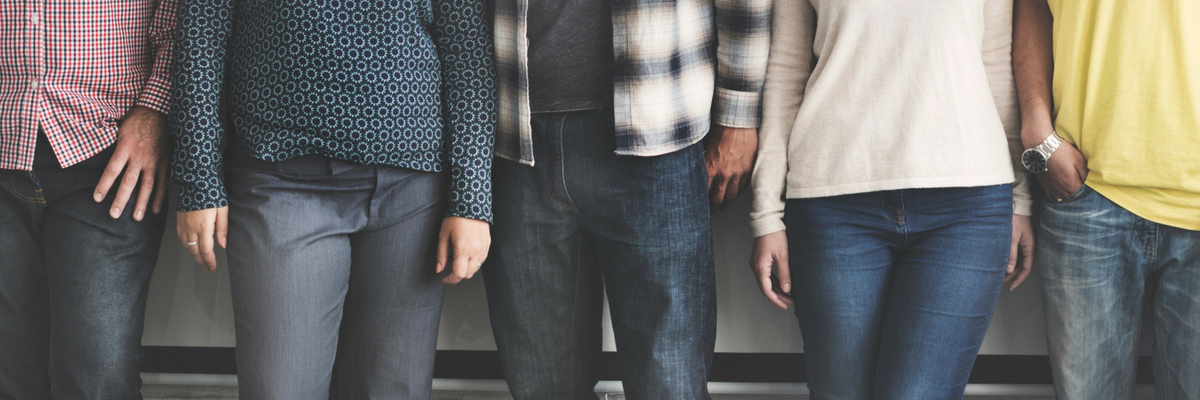 Small group of people stand next to each other | Sparkhouse Blog