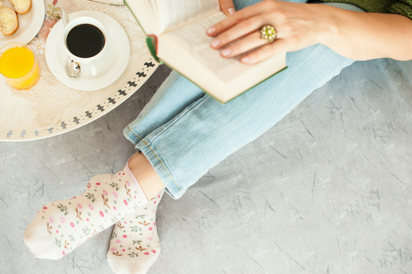 Woman reads a Bible and eats breakfast in bed | Sparkhouse Blog