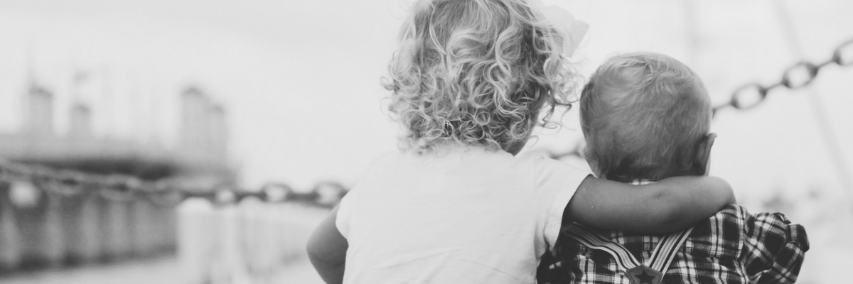 Two babies sit together on a dock | Sparkhouse Blog